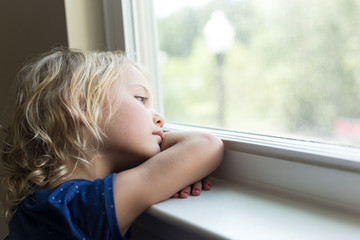 Little girl looking out the window