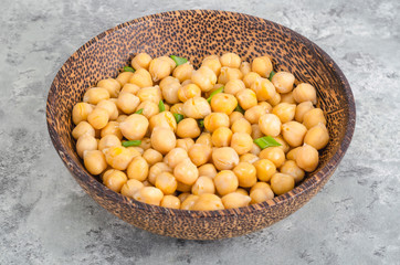 Canned chickpeas in wooden bowl.