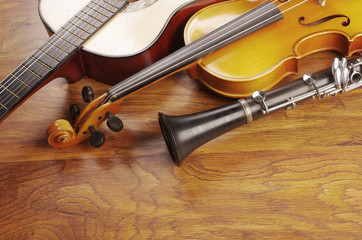 Fototapeta na wymiar Violin, guitar, clarinet on a wooden table