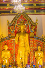 Beautiful large standing golden Buddha image with ceiling interior decoration, named Phra Chao Attarot at Wat Chedi Luang (temple of the big royal stupa), located in Chiang Mai, Thailand.