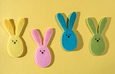 Obraz premium Easter bunnies on yellow background.