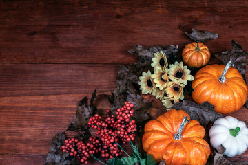 Thanksgiving decor with candle, pine cones, sunflowers, acorns, pumpkins, squash, guard, berries and  leaves