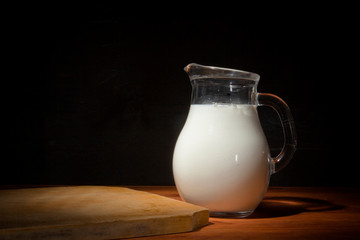 Glass jug with milk