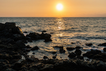 Rock coast of Thailand gulf sea at sunset
