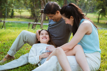 The daughter laying down on her parents