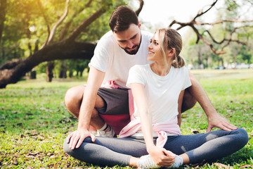 Young couple stretching at the park