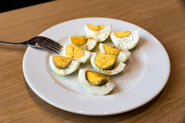 Boiled eggs with salt pepper and olive oil