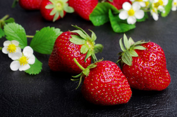 Ripe strawberries on a dark, close-up
