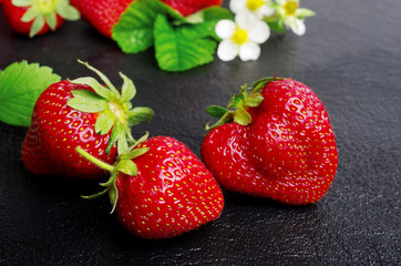 Ripe strawberries on a dark, close-up