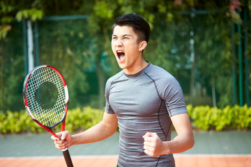 young asian male tennis player celebrating success