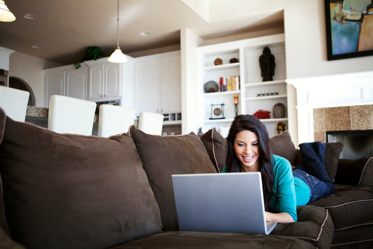 Woman Sitting At Home With Computer 