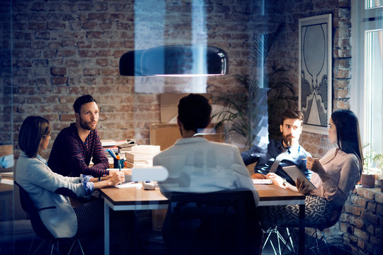 Five people sitting in office during meeting 