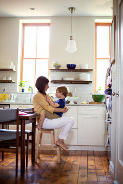 Mother with son (2-3) in kitchen 