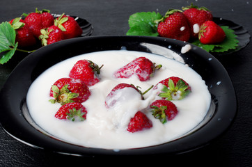 Ripe strawberries in a cream platter.