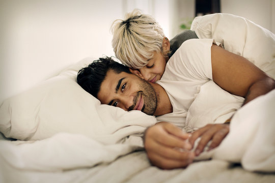 Young couple lying in bed 