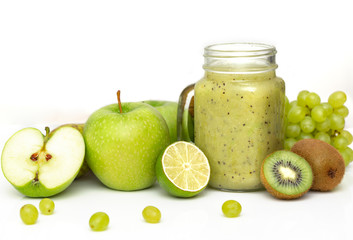 Green healthy smoothie in glass jar: kiwi, grapes, pear, green Apple, lime and avocado. Vegan, vegetarian food concept. Healthy diet. 