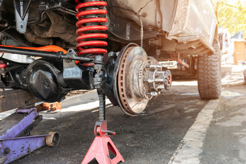 The front wheel of the car was removed to repair the brake system, Automotive industry and garage...