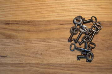Grouping of Old Skeleton Keys Laying on a Wood Table