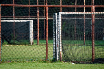 Rust steel net with blur football field.