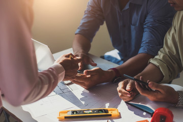 engineer people meeting working and pointing at a drawings in office for discussing. Engineering tools and construction concept.