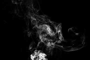Smoke the white incense on a black background. darkness concept
