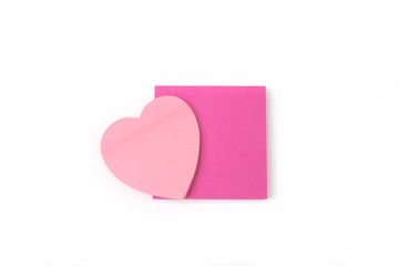 Close up of a Pink heart shaped post-it and Adhesive Note