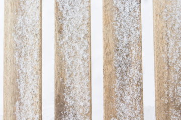 Brown wooden background with snow