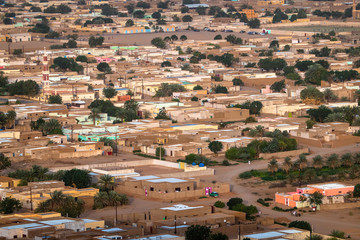 Aerial view of a typical village in Sudan near the Nile, with flat loam buildings and colourful...