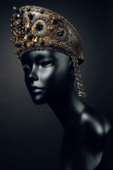 Mannequin head in creative metallic kokoshnick with skulls