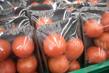 tomatoes in plastic containers packed