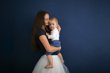 Cute Caucasian mom with long hair with baby