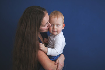 Mom and son baby together on blue background