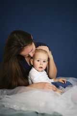 Mom and son baby together on blue background