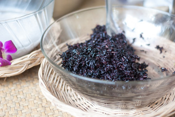 Black rice in transparent bowl ready to put coconut milk in, Thailand dessert
