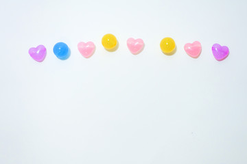 Colorful stones in heart shape on white background