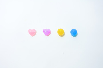 Colorful stones in heart shape on white background