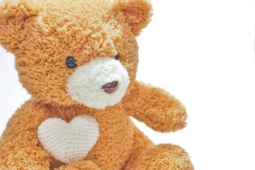 Brown bear doll hold white heart on hand on white background. A brown bear doll for valentines.