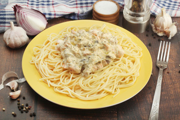 A plate with pasta with salmon