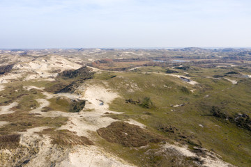 Dutch dunes by the sea from above in mystical late afternoon sun