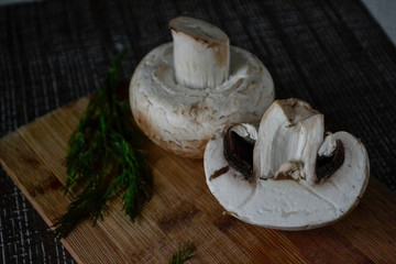 fresh mushrooms with herbs on a cutting board