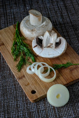 fresh mushrooms with herbs on a cutting board