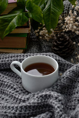 coffee and books on a cozy blanket with flowers