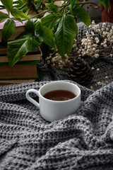 coffee and books on a cozy blanket with flowers