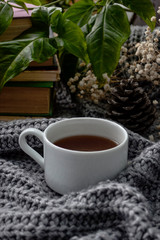 coffee and books on a cozy blanket with flowers
