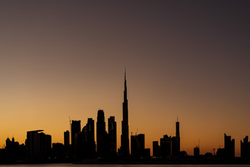 Fototapeta na wymiar Silhouette of Dubai cityscape with Burj Khalifa at Magic Hour