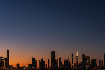 Fototapeta premium Silhouette of Dubai cityscape at Magic Hour