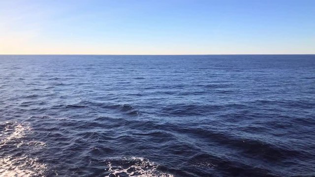 Blue Ocean with Yacht boat wake foam of prop wash.