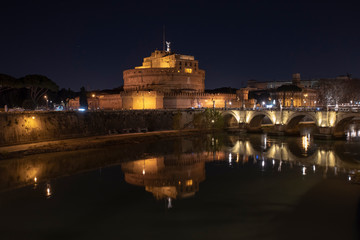 Rome Italy. Beautiful view of Castel Sant'Angelo and the bridge at night with reflections on the Tiber river.