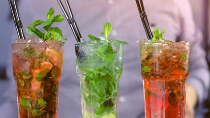 Alcohol cocktails with tequila, mint and ice in glasses.