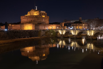 Fototapeta na wymiar Rome Italy. Beautiful view of Castel Sant'Angelo and the bridge at night with reflections on the Tiber river.